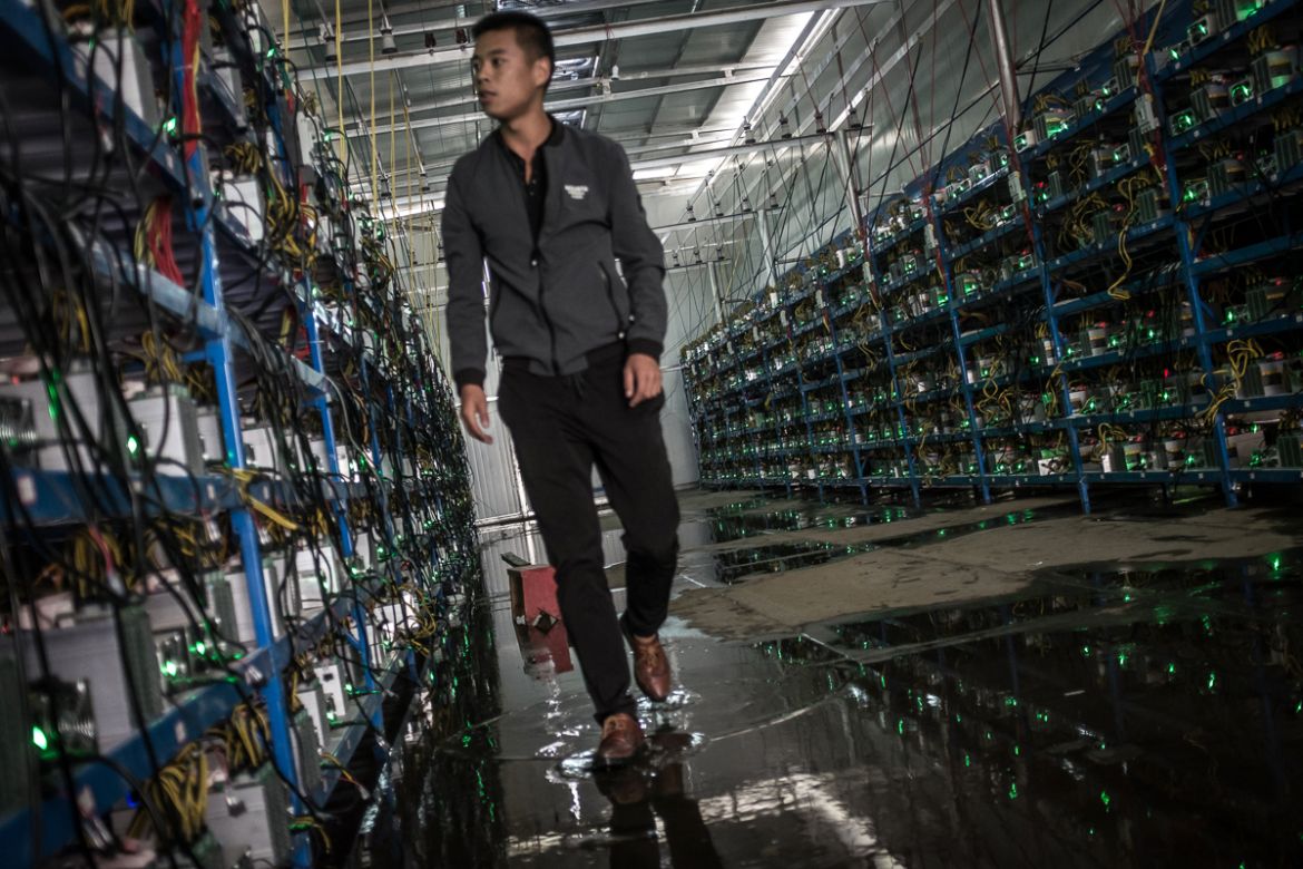 Tibetan Bitcoin mine manager Kun walks in between aisles of mining machines in a Bitcoin mine in Sichuan Province, China, 26 September 2016. Kun is the mine''s manager as well as one of its investors.