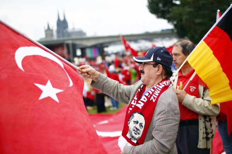 Supporters of Turkish President Erdogan wave Turkish flags during a pro-government protest in Cologne
