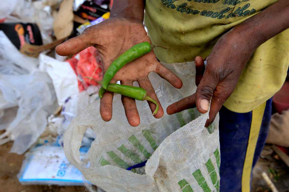 Ayoub Mohammed Ruzaiq, 11, holds green peppers he found at a garbage dump near the Red Sea port city of Hodeidah, Yemen, January 09, 2018. "We eat and drink the food that is thrown away," said Ayoub.