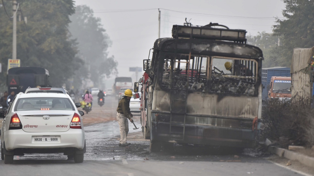 A bus was set on fire by protesters in Gurugram [Sanjeev Verma/Hindustan Times via Getty Images]