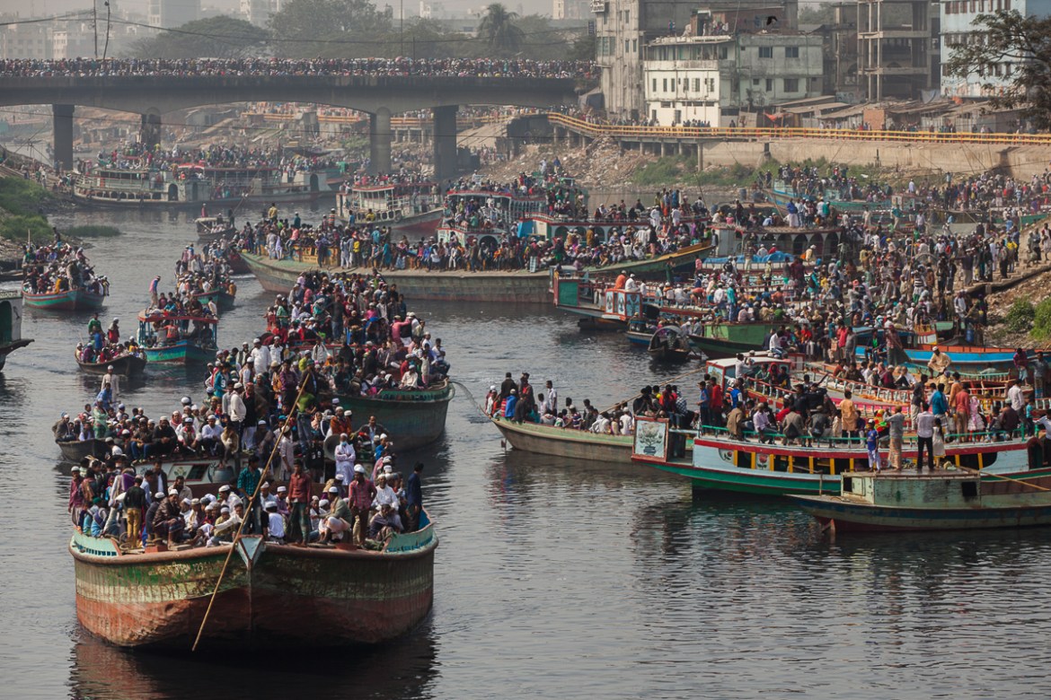 Devotees return home riding on an overcrowded Boat after attending the Akheri Munajat, concluding prayers on the third day. [Mahmud Hossain Opu/Al Jazeera]