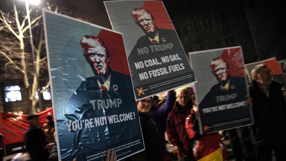 Protester rally against the attendance of Trump at the upcoming Davos World Economic Forum [Philippe Desmazes/AFP]