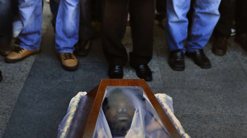 Mourners gather in front of the coffin of Shahzad Luqman in January 2013 [Yannis Behrakis/Reuters] 
