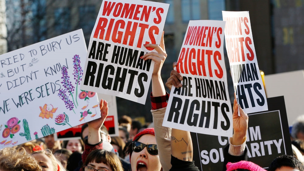 Women chant and raise their signs during a 2017 rally, part of International Women's Strike NYC, a coalition of dozens of grassroots groups and labour organizations [File: Kathy Willens/AP Photo]