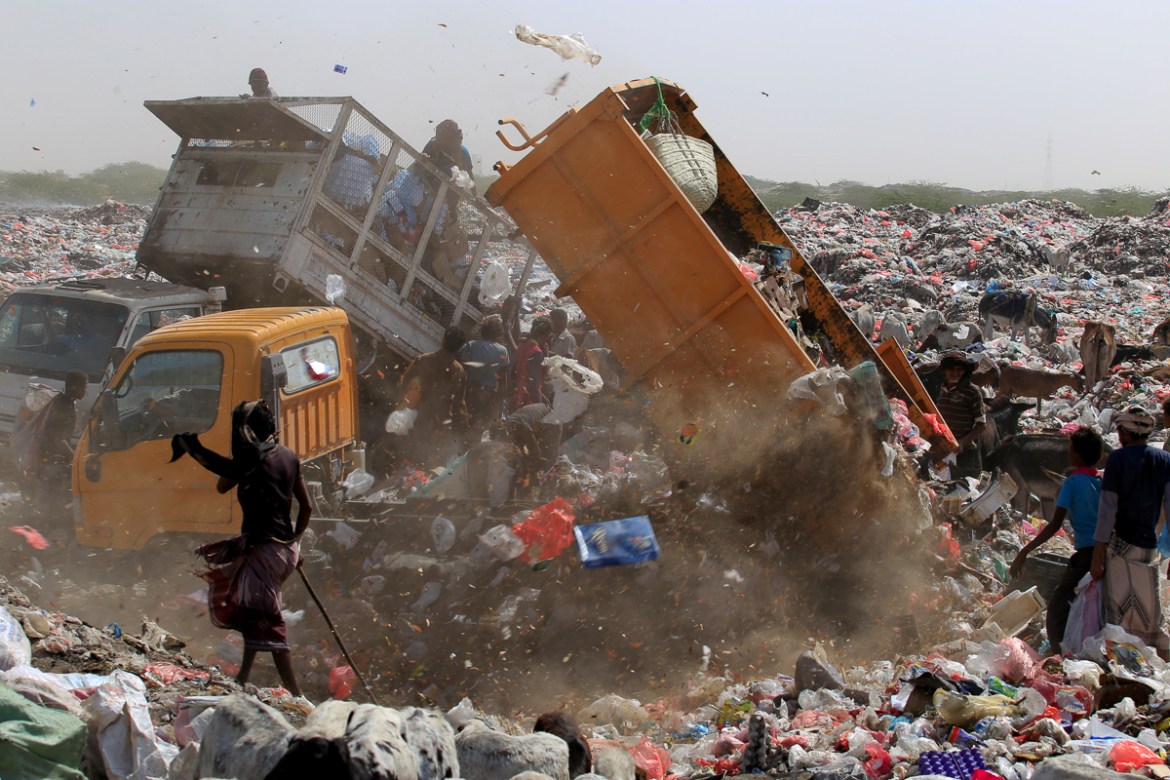 People collect recyclables and food at a garbage dump near the Red Sea port city of Hodeidah, Yemen