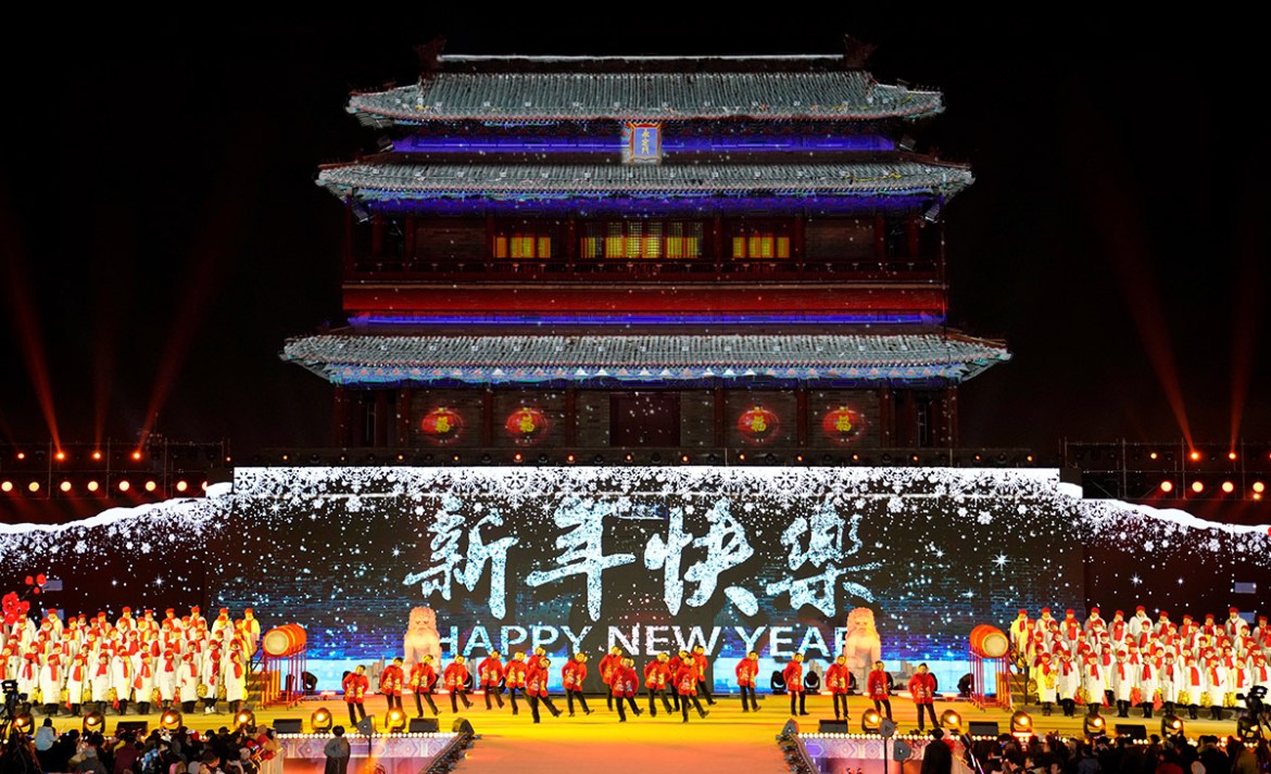 People dance to celebrate the new year during a countdown event at Yongdingmen Gate in Beijing, China, December 31, 2017. REUTERS/Jason Lee