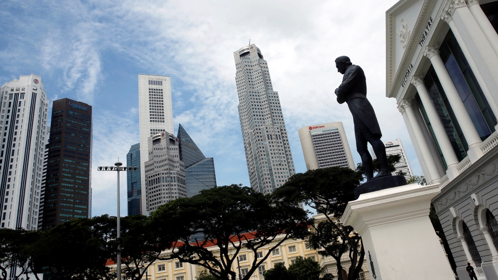 A statue of Sir Stamford Raffles stands next to the Victoria Theatre in the  Central Business District of Singapore [Reuters/Edgar Su]
