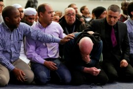 A man is comforted as he cries during a funeral ceremony for three of the victims of the deadly shooting of the Quebec Islamic Cultural Centre at the Congress Center in Quebec City