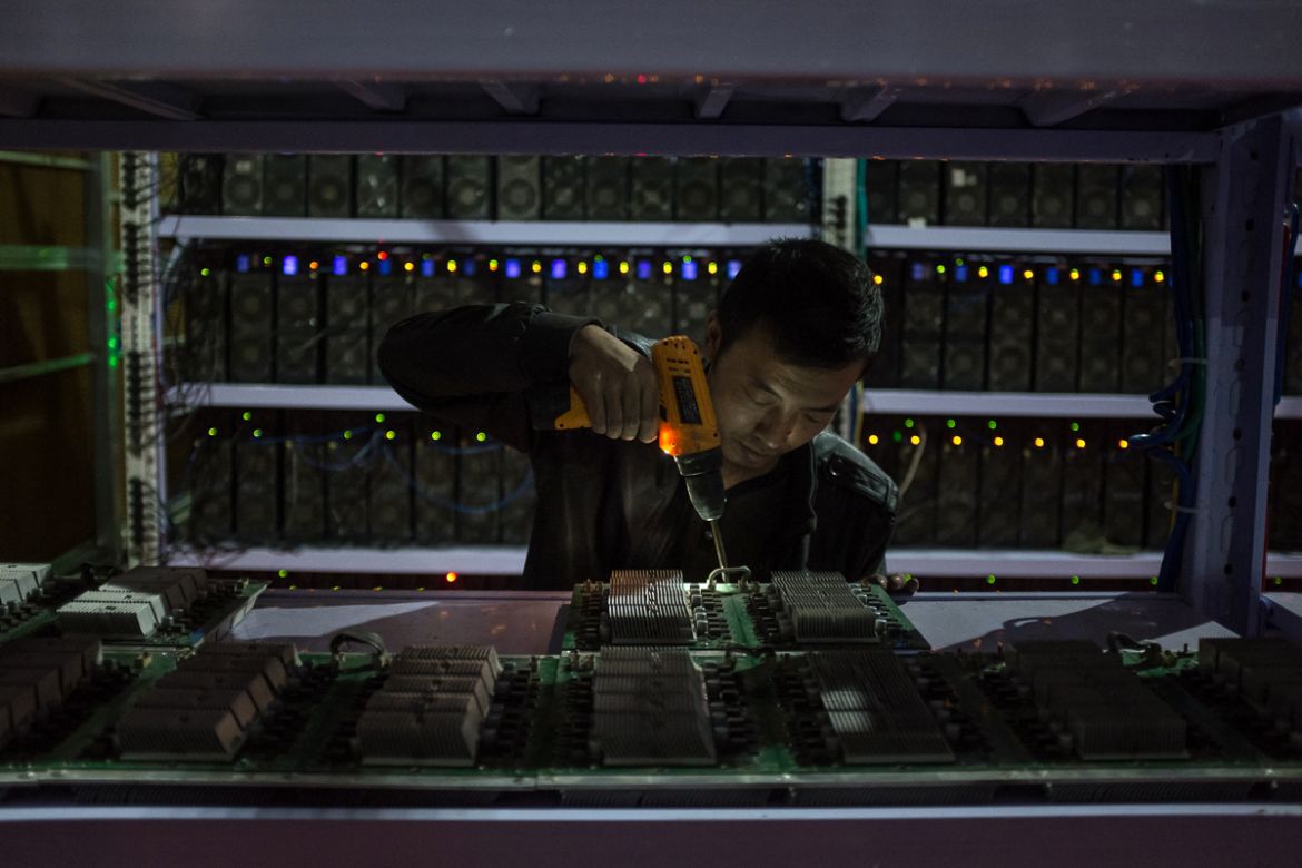 An employee resembles calculation board at a Bitcoin mine in Sichuan Province, China, 27 September 2016.