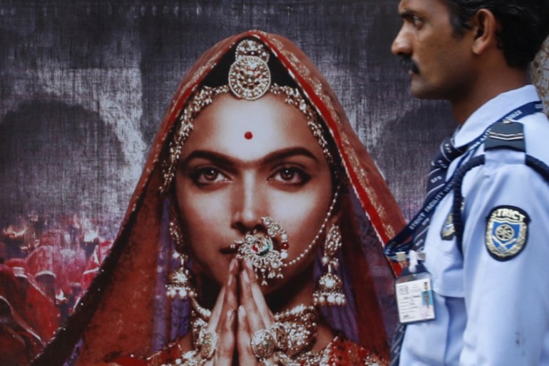A security guard walks past a poster of the upcoming Bollywood movie ''Padmavati'' outside a theatre in Mumbai