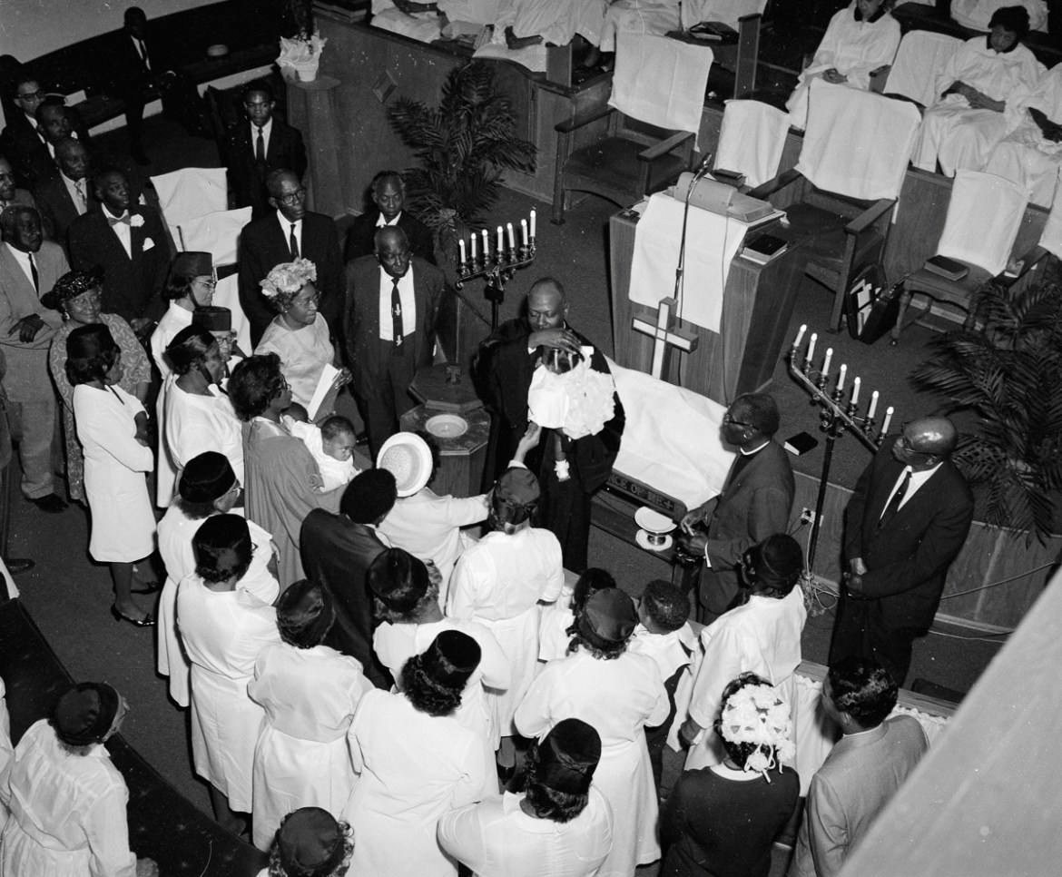 5: A minister baptizes a child at Allen Chapel in Fort Worth on Easter Sunday in 1969. Calvin Littlejohn was everywhere—he had to be for his photography studio work and occasional freelance photograph