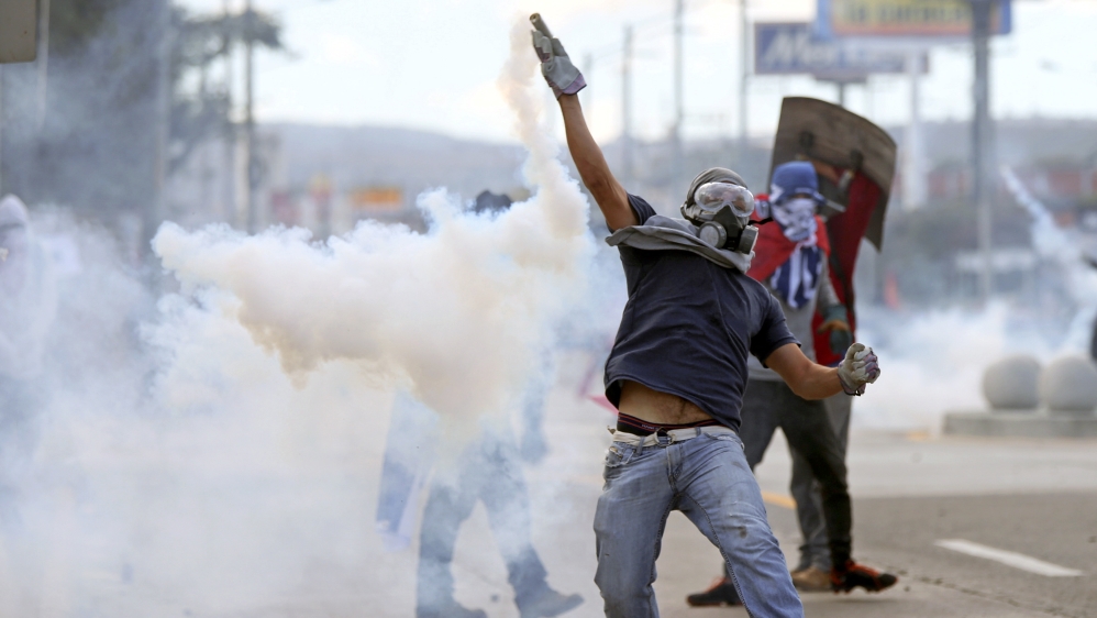 Security forces deployed tear gas at the opposition march [Edgard Garrido/Reuters]