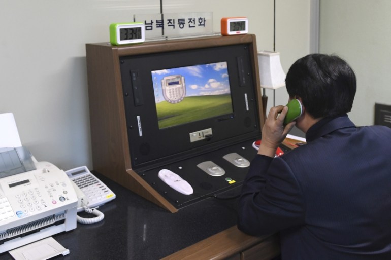 A South Korean government official communicates with a North Korean officer during a phone call on the dedicated communications hotline at the border village of Panmunjom in Paju, South Korea