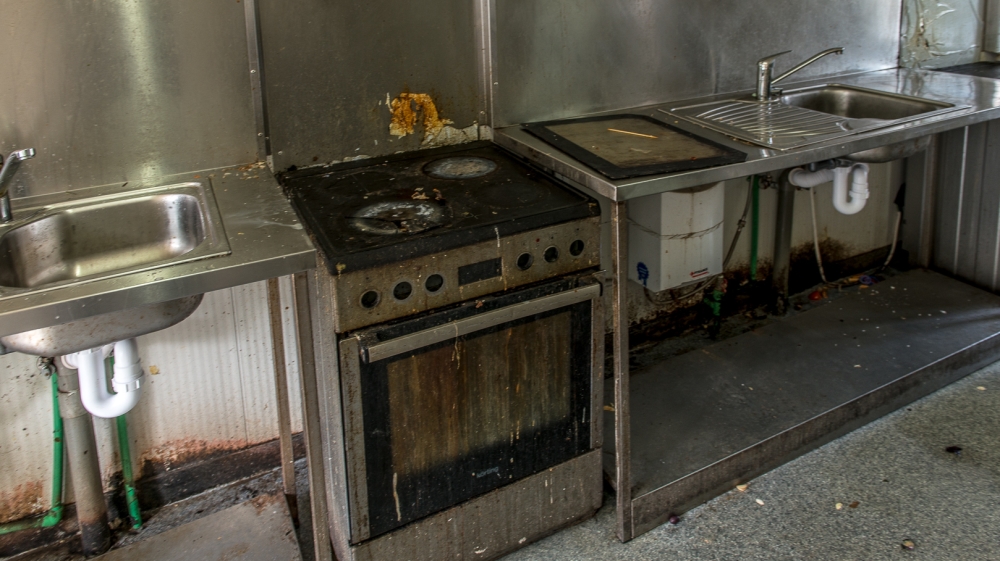 Humanitarian groups say the conditions at the shared kitchens have deteriorated to a state of being a health risk [Dimitris Sideridis/Al Jazeera]