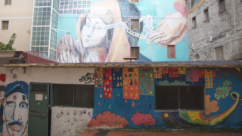 Artists have decorated the outer walls of the former hospital [Ylenia Gostoli/Al Jazeera]