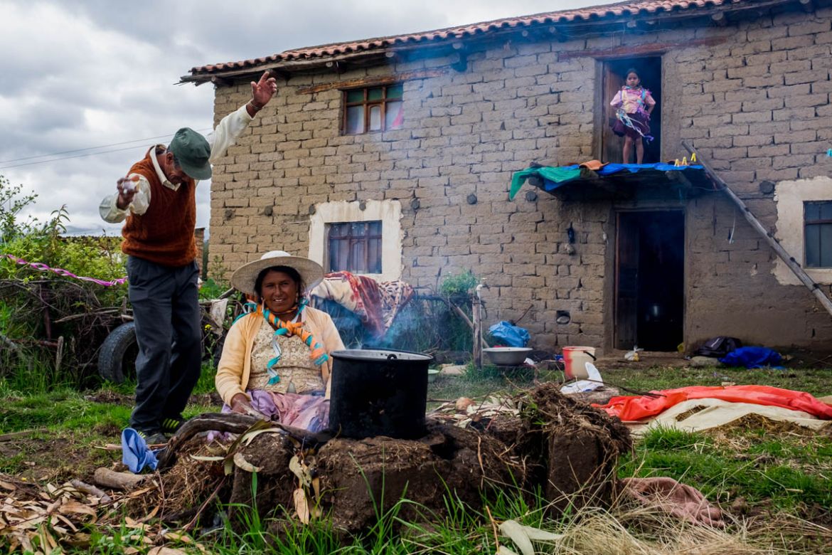 Froylan Fernandez dances in his backyard while his wife Emilia Garcia, decorated with serpentines, prepares a meal (13-2-2018). Martes de Ch’alla’is usually celebrated in family sphere. Their grandda