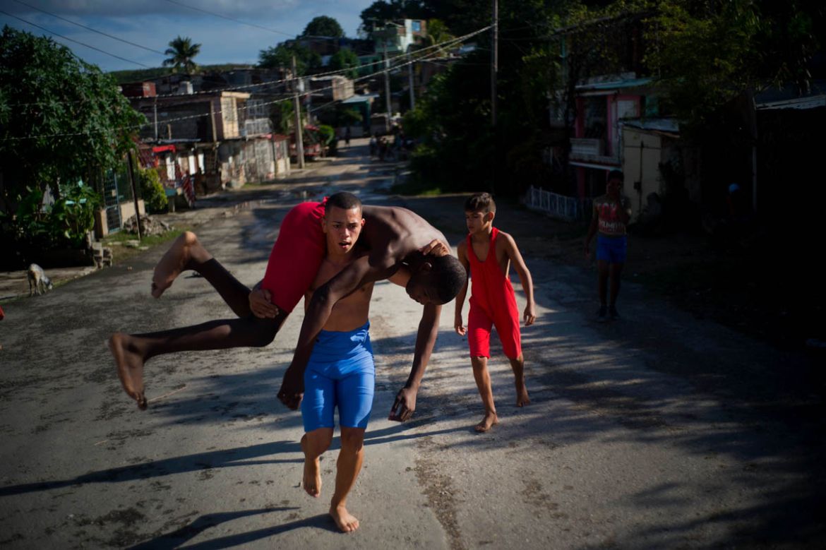 In this Jan. 22, 2018 photo, young wrestlers train in the street during the week-long student wrestling championship coined "The truth of my neighborhood," organized by locals in the Chicharrones neig
