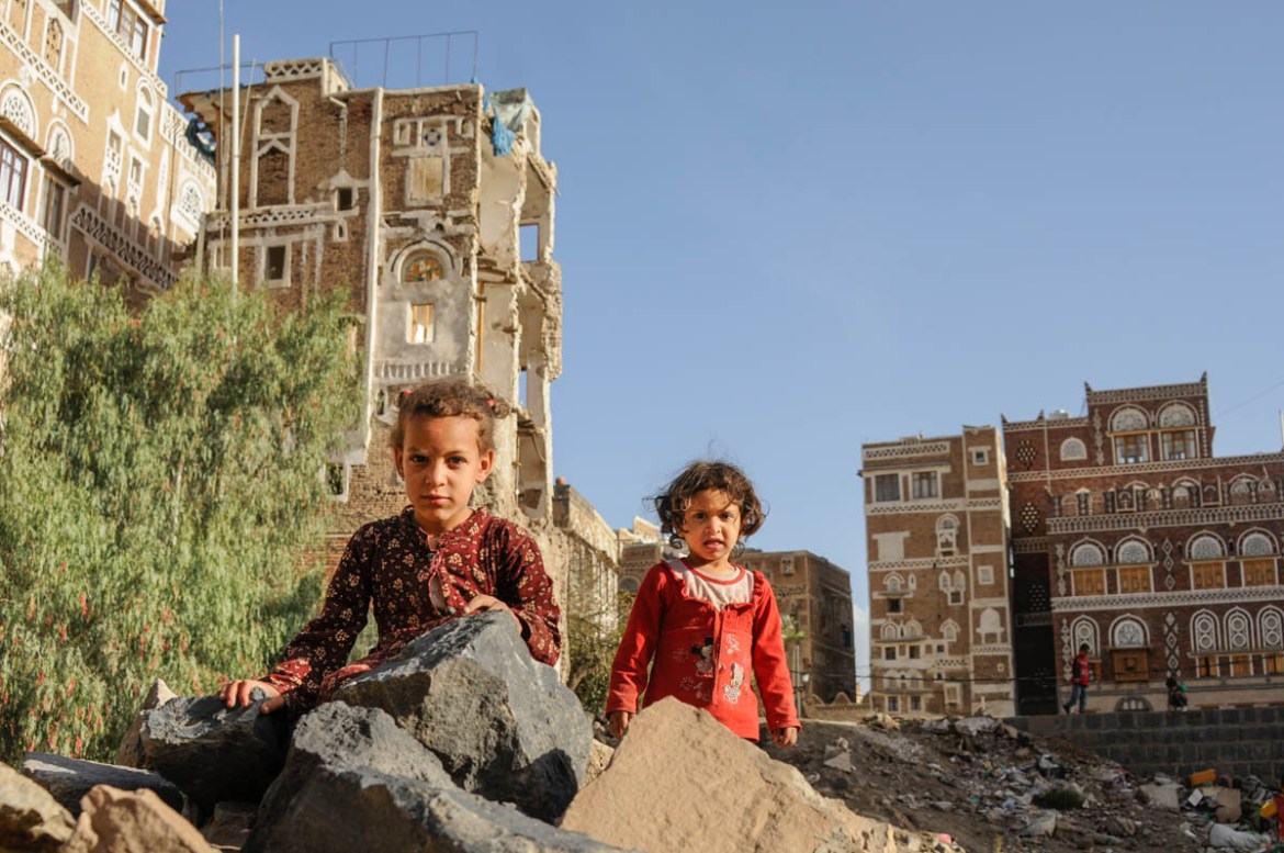 Sisters Eman and Amani Asabah play among rubble and debris in the Old City of Sana’a. After their house was destroyed in the war they fled with their family from the Old City but have since returned t