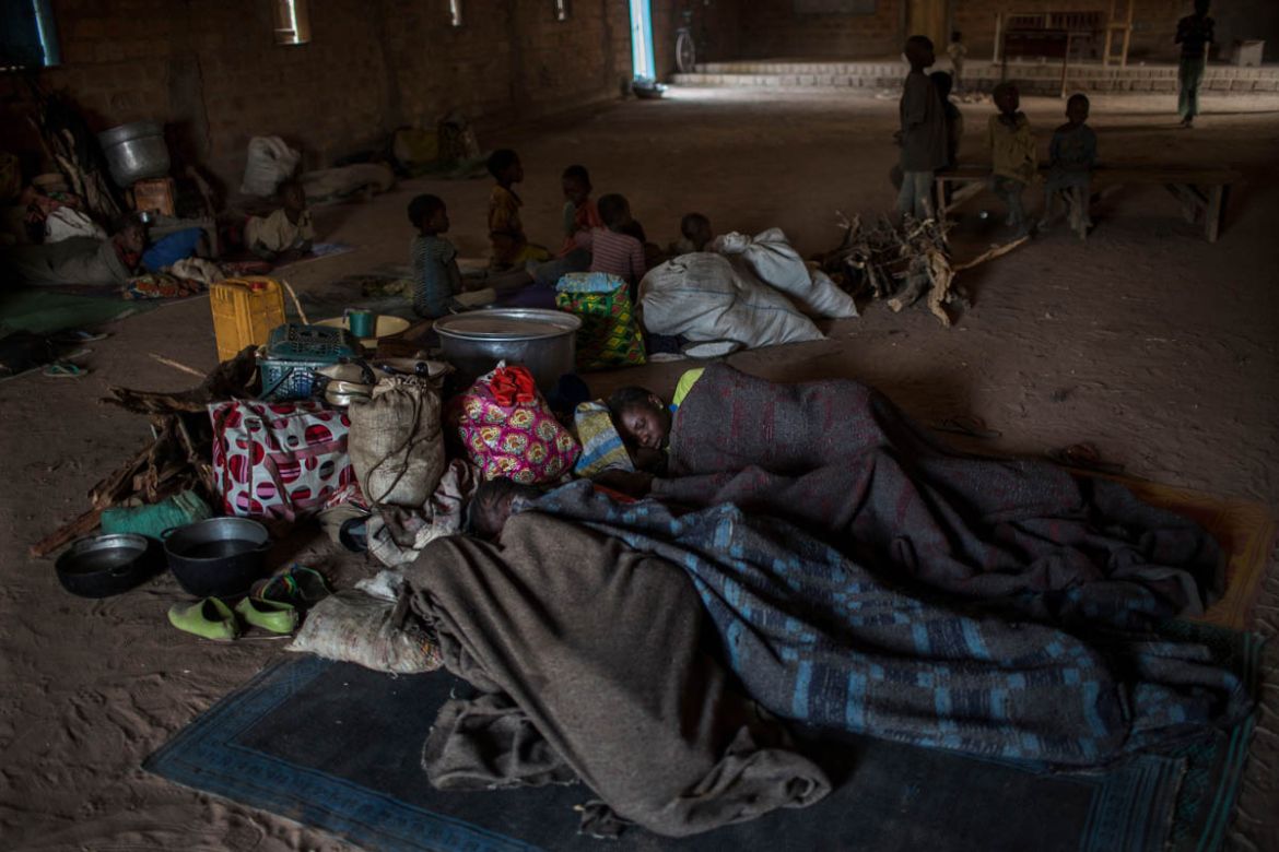 IDPs sleeping on the floor of Saramandja Church try to stay warm with blankets in Paoua, Central African Republic, February 1, 2018. The majority of those displaced recently in Ouham-Pende prefecture