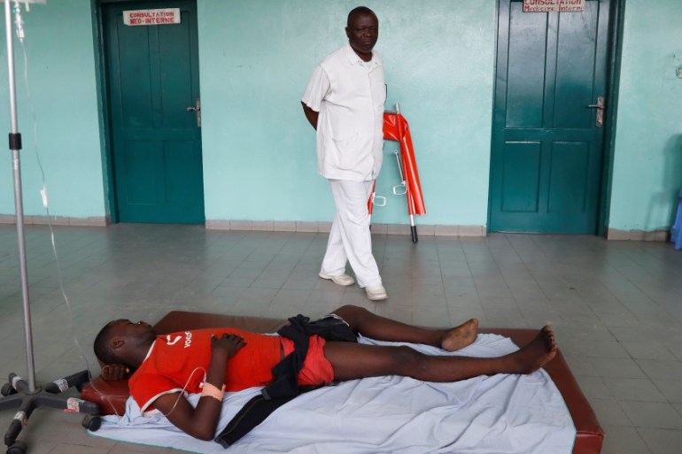 A protester, who was shot in the leg by police during a protest, lies in a hospital in Kinshasa