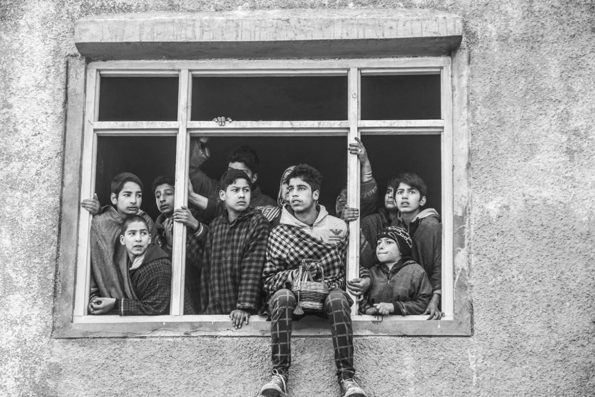Children watching funeral procession of a slain militant from a house at village Hablish  in Kulgam district, about 72 km south of Srinagar city, the summer capital of Indian-controlled Kashmir.