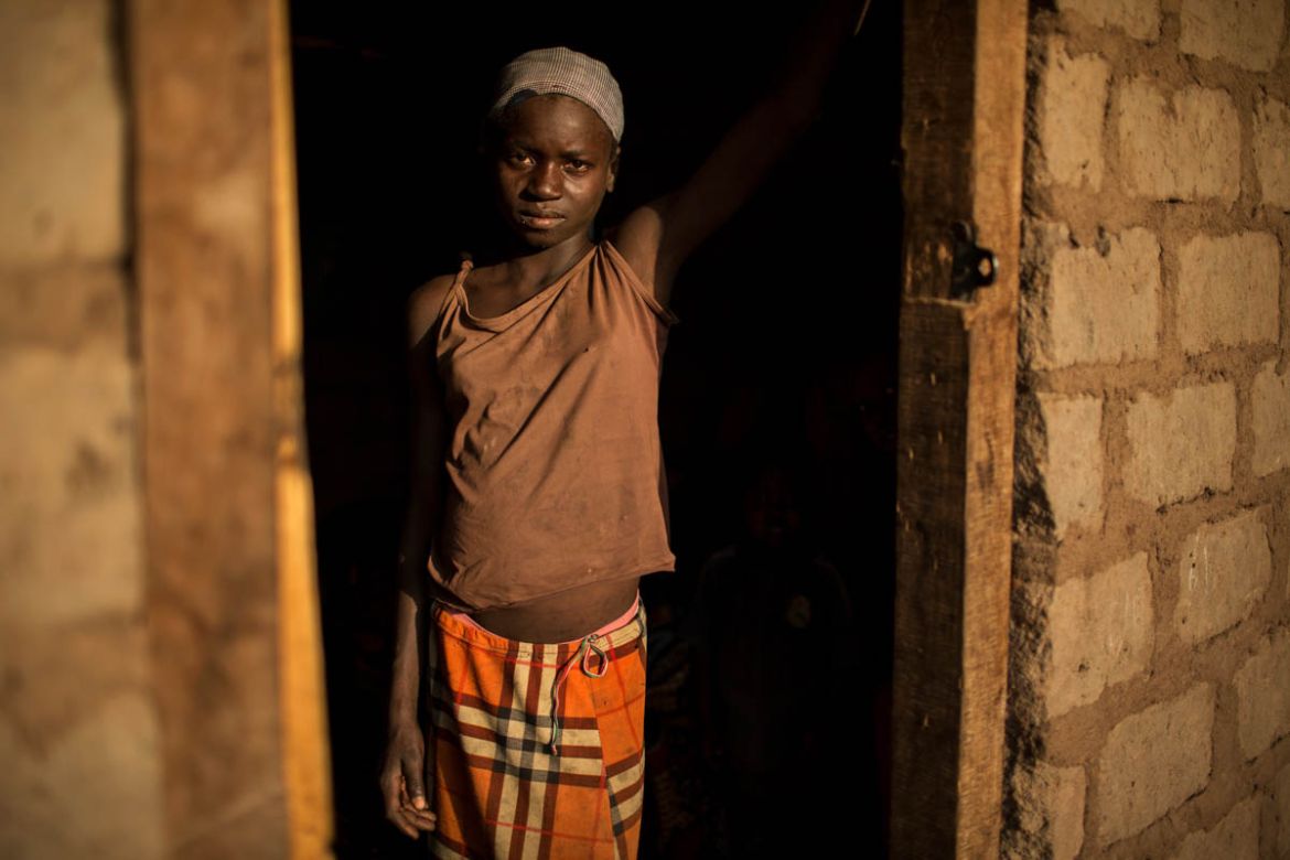Abigaelle Benonkoumte, 13, stands in the doorway of a previously abandoned house that she and her extended family have taken shelter in in Paoua town after fleeing violence in late December when the N
