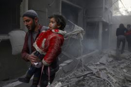 Man holds child after airstrike in besieged town of Douma, Eastern Ghouta, Damascus