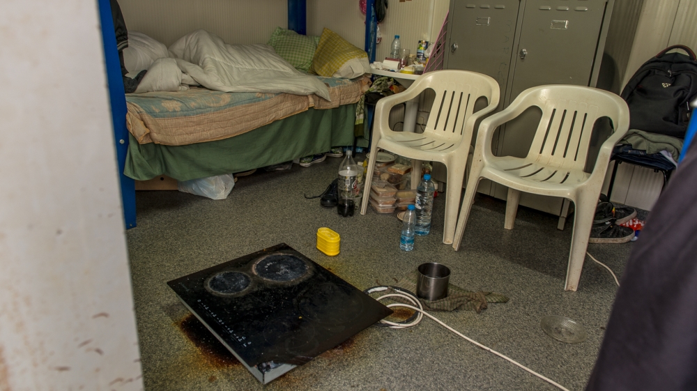 A kitchen stove provides heating in one of the centre's rooms [Dimitris Sideridis/Al Jazeera]