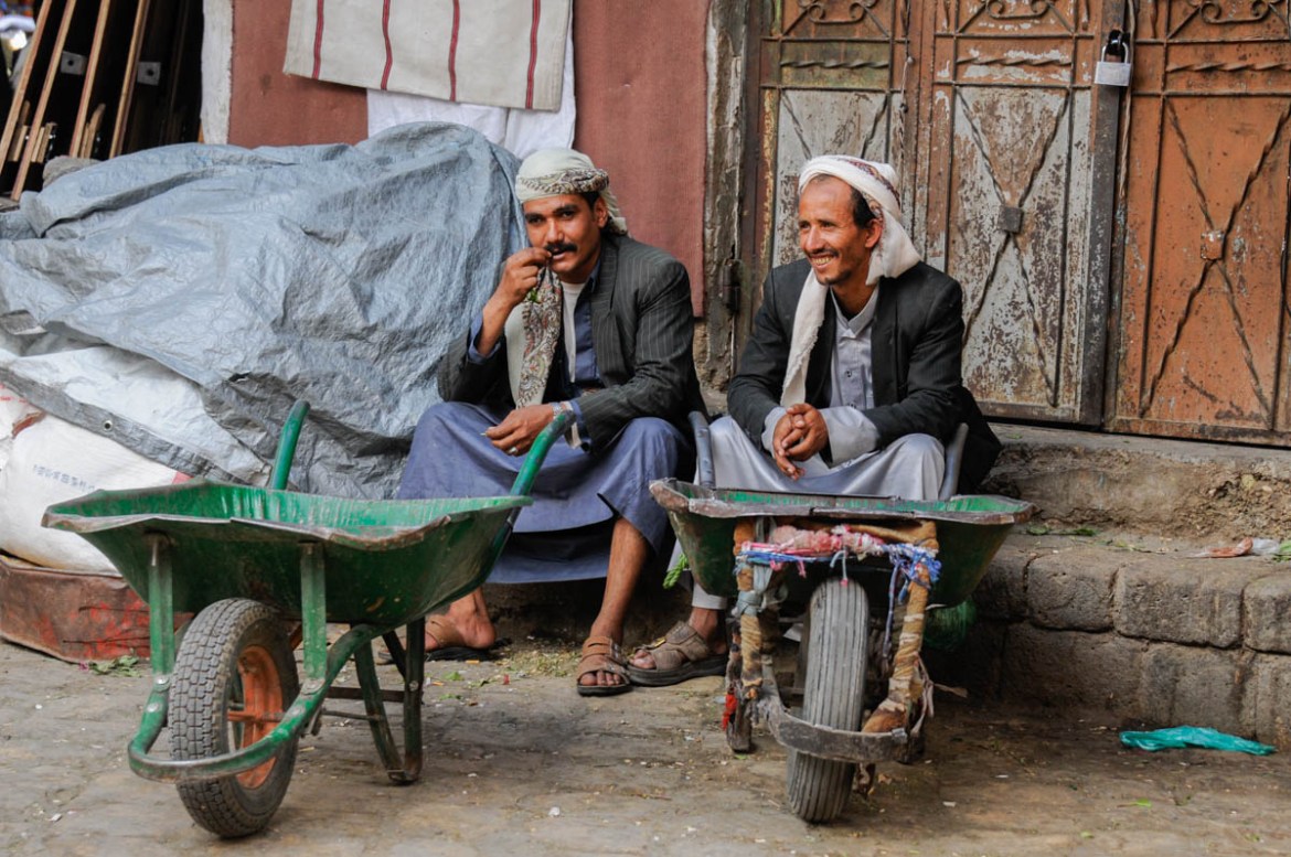 Waiting for customers at Sana’a’s Old City, Mahmood Mohammed (left) supports five members of his family with the modest income he receives as a porter at the market. With his family displaced by war,