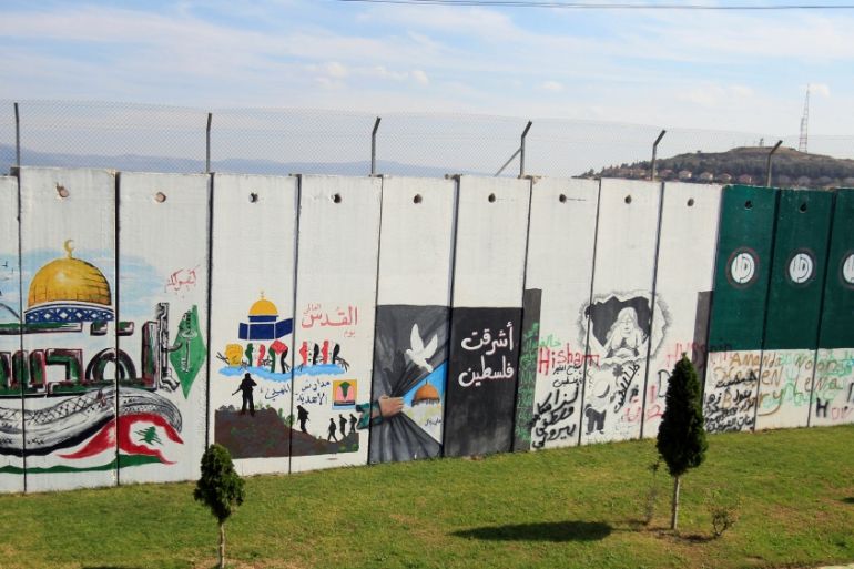A wall decorated with graffiti is seen at Kfar Kila village near the Lebanese-Israeli border