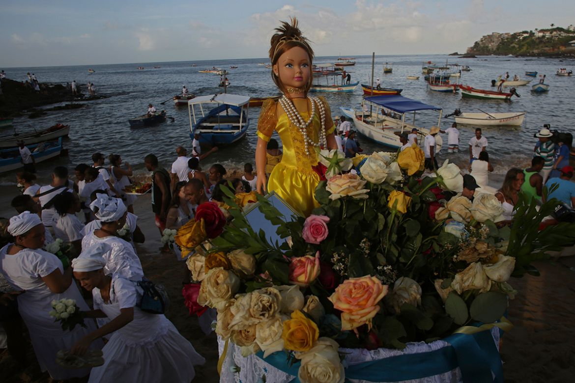 In this Feb. 2, 2018 photo, a large doll representing sea goddess Yemanja is taken to the sea from Red River Beach in Salvador, Brazil. Thousands of Brazilians have flooded the city''s beaches in the n