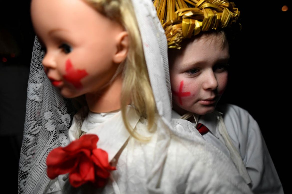 Shane Cahill, 12, carries a Brideog effigy doll before participating in a Biddy''s Day parade to celebrate the Celtic festival of Imbolc, which is the arrival of springtime, in Killorglin, Ireland, Feb