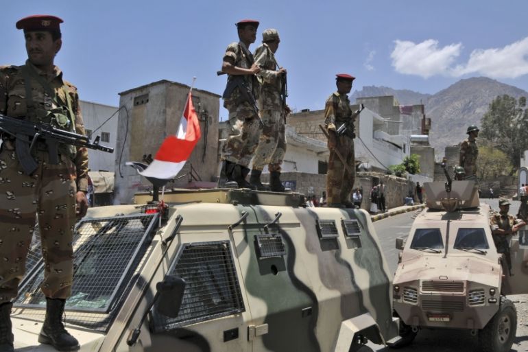 Yemeni army soldiers block the way during a demonstration by anti-government protestors, not seen, demanding the resignation of Yemeni President Ali Abdullah Saleh, in Aden, Yemen, 2011