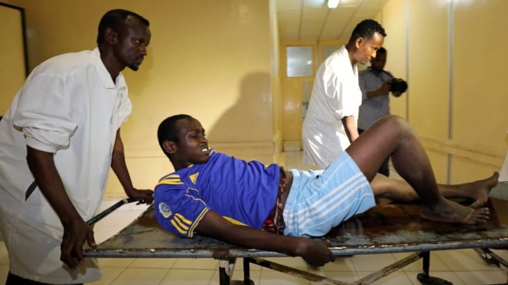 A wounded civilian arrives for medical treatment at the Madina Hospital after he was injured during an explosion near the Presidential palace in Mogadishu