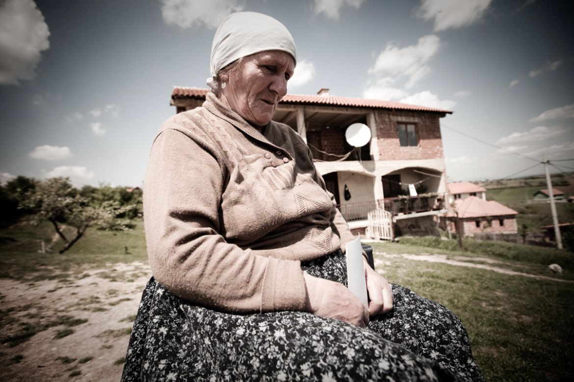 A woman in front of her home destroyed by Serbs during the war. Her husband was killed and her son is still missing after it was captured Serbs in Village Morina in Drenica region.