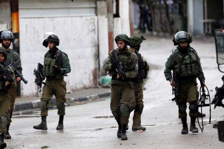 Israeli soldiers are seen during clashes with Palestinians in the West Bank city of Jenin