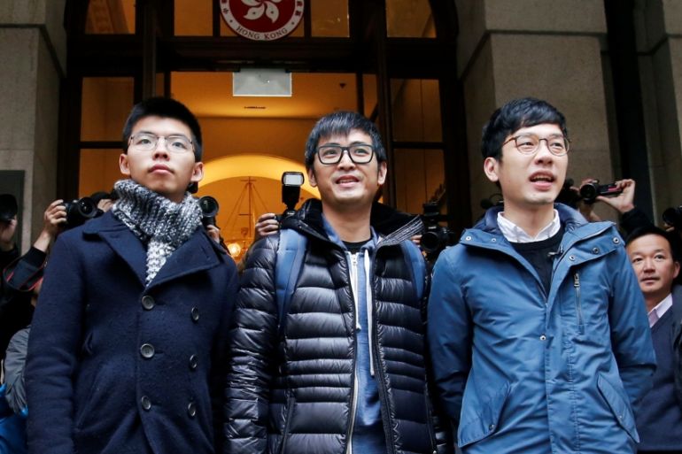 Pro-democracy activists Joshua Wong, Alex Chow and Nathan Law pose outside the Court of Final Appeal in Hong Kong