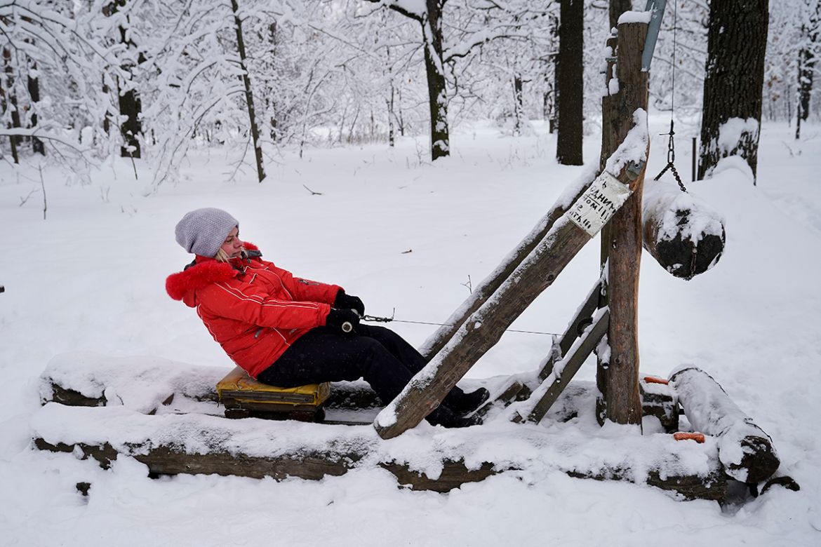A woman trains in the outdoor gym in Timiryazevsky Park in Moscow, Russia, Wednesday, Feb. 7, 2018.. The morning temperature in Moscow is approximately -10 degrees Celsius (14 Fahrenheit). (AP Photo/A