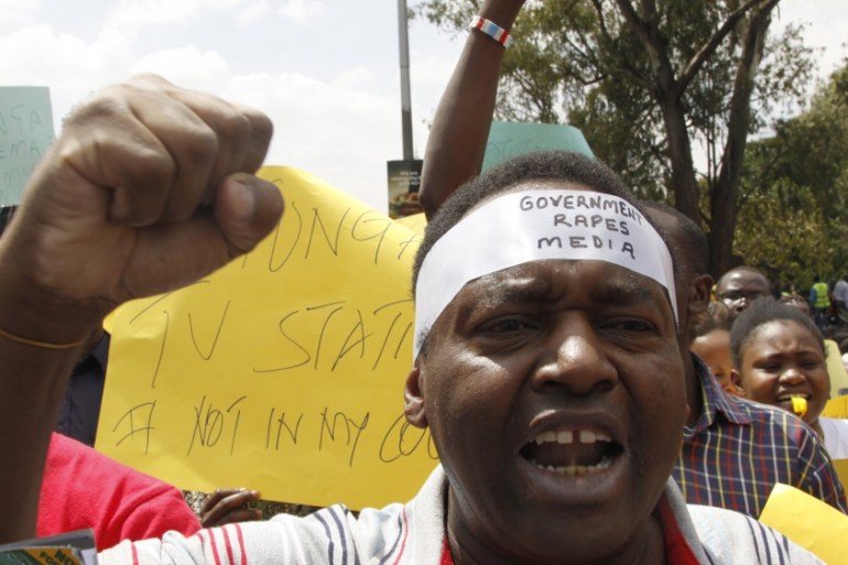 Kenya civil rights groups protest on the streets of Nairobi holding placards against the government closure of the three main TV stations in Nairobi, Kenya Monday, Feb. 5, 2018