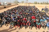 Migrants sit at a detention centre in Gharyan, Libya [Hani Amara/Reuters]
