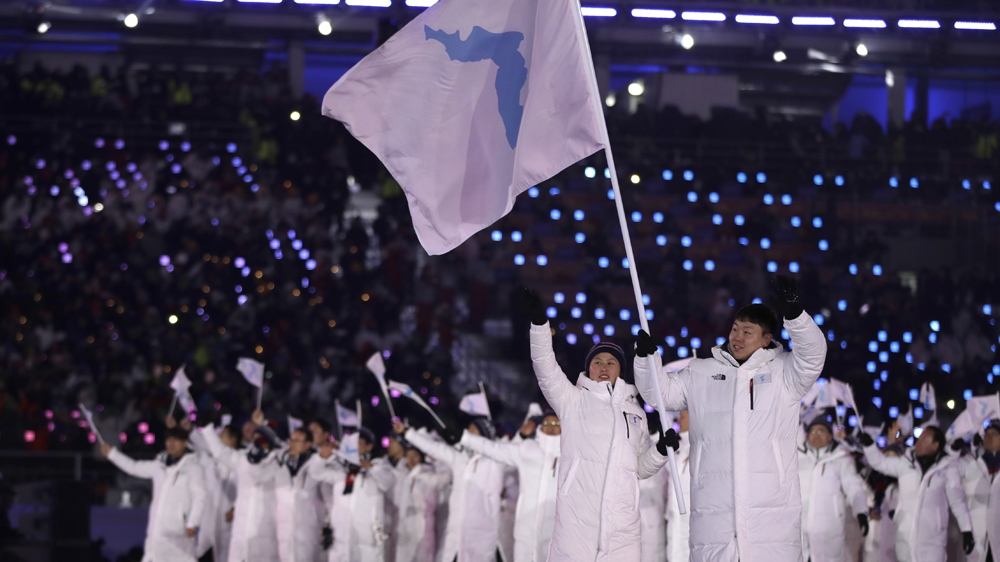 Loud cheers greeted the South and North Korean teams, as they marched together at the opening ceremonies on Friday [AP]