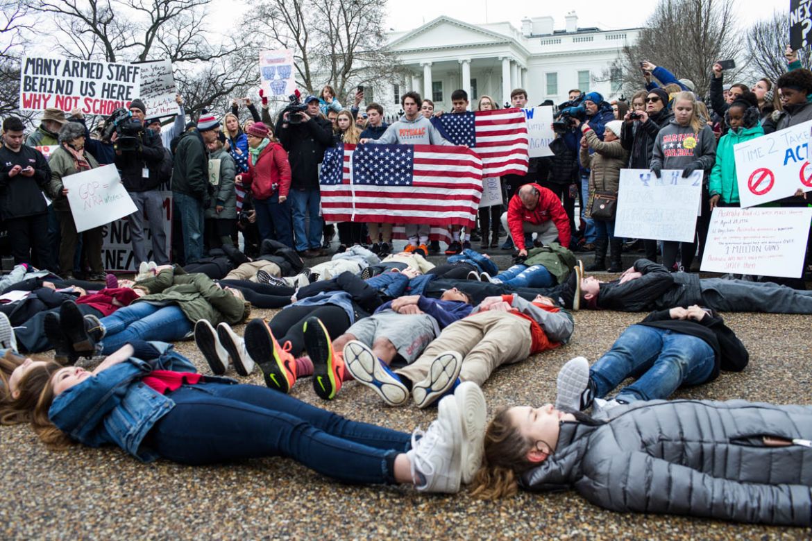 Demonstrators lie on the ground a ''lie-in'' demonstration supporting gun control reform near the White House on February 19, 2018 in Washington, DC. According to a statement from the White House, ''the