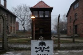 A sign reading &#34;Stop!&#34; in German and Polish is seen at the former Nazi German concentration and extermination camp Auschwitz in Oswiecim, Poland, in 2018 [File: Kacper Pempel/Reuters]