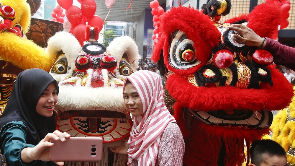 Celebrations at a shopping centre before Lunar New Year in Kuala Lumpur, Malaysia [Sadiq Asyraf/AP]