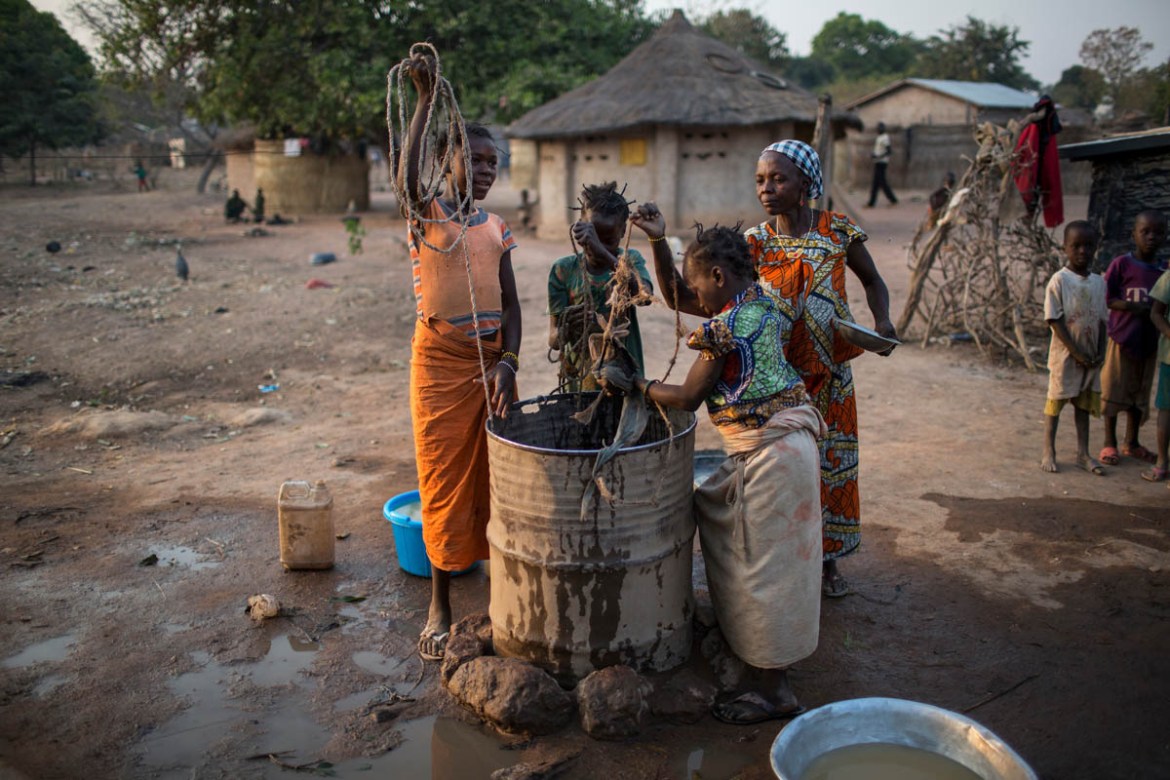Displaced girls staying with a host family draw water from a well in Paoua, Central African Republic, January 28, 2018. “The wells constructed in Paoua were only meant for 40,000 people, the populatio