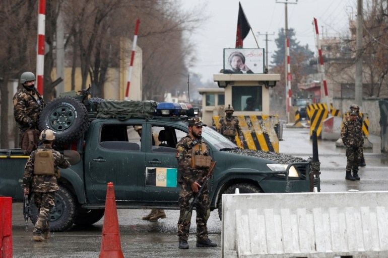 Afghan security forces keep watch at a check point near the site of a suicide attack in Kabul