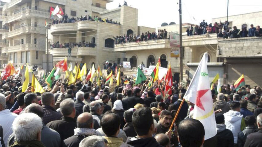 Syrian Kurdish demonstrators gather in Afrin on Tuesday to protest against Turkey [AP]