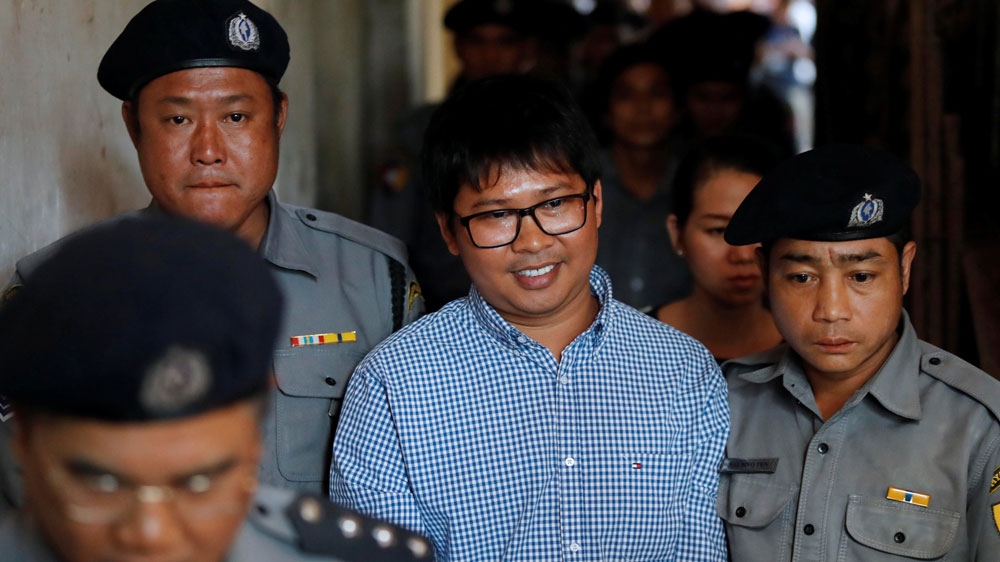 Arrested Reuters journalist Wa Lone is being escorted by police after a court hearing in Yangon, Myanmar February 1, [Jorge Silva/Reuters]