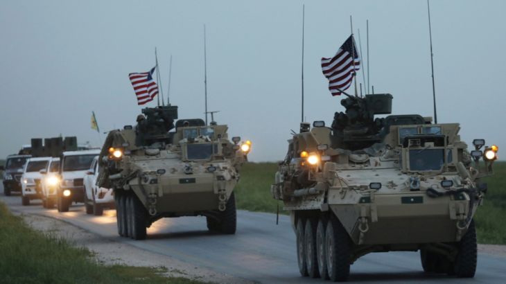 U.S military vehicles and Kurdish fighters from the People''s Protection Units (YPG) drive in the town of Darbasiya next to the Turkish border
