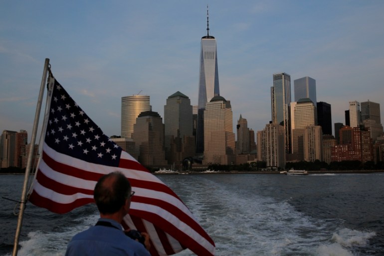 A man looks back toward lower Manhattan and One World Trade Center while riding the Liberty Landing Ferry across the Hudson River on the 16th anniversary of the September 11 attacks in New York, U.S.